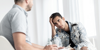 Image of a distressed student speaking to an academic counsellor